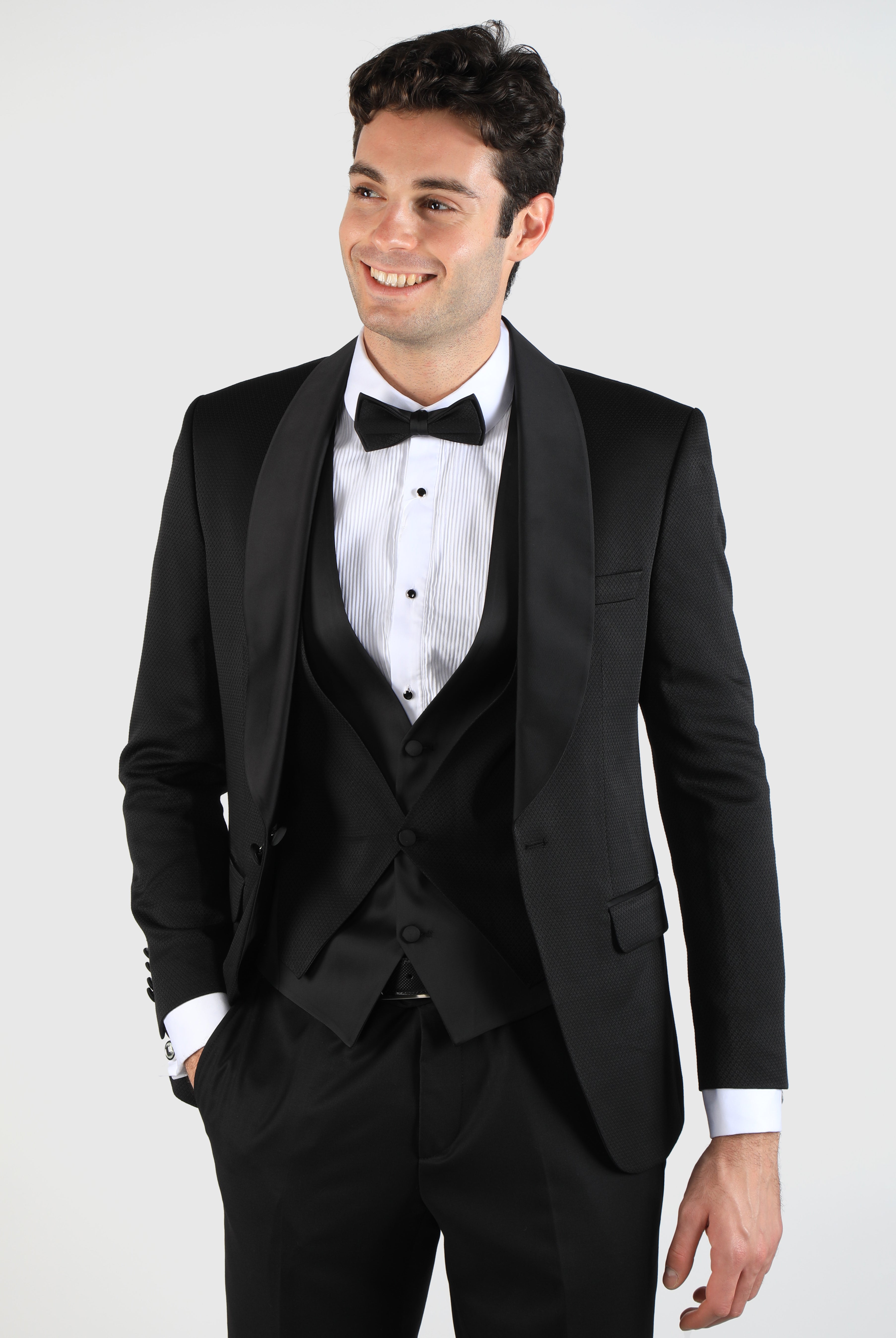 alt="DKS black slim tuxedo suit with vest front close view on model"