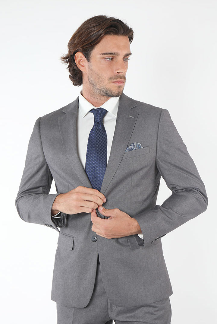 alt="Francisco Tolli light grey slim plain suit side view with modern cut"