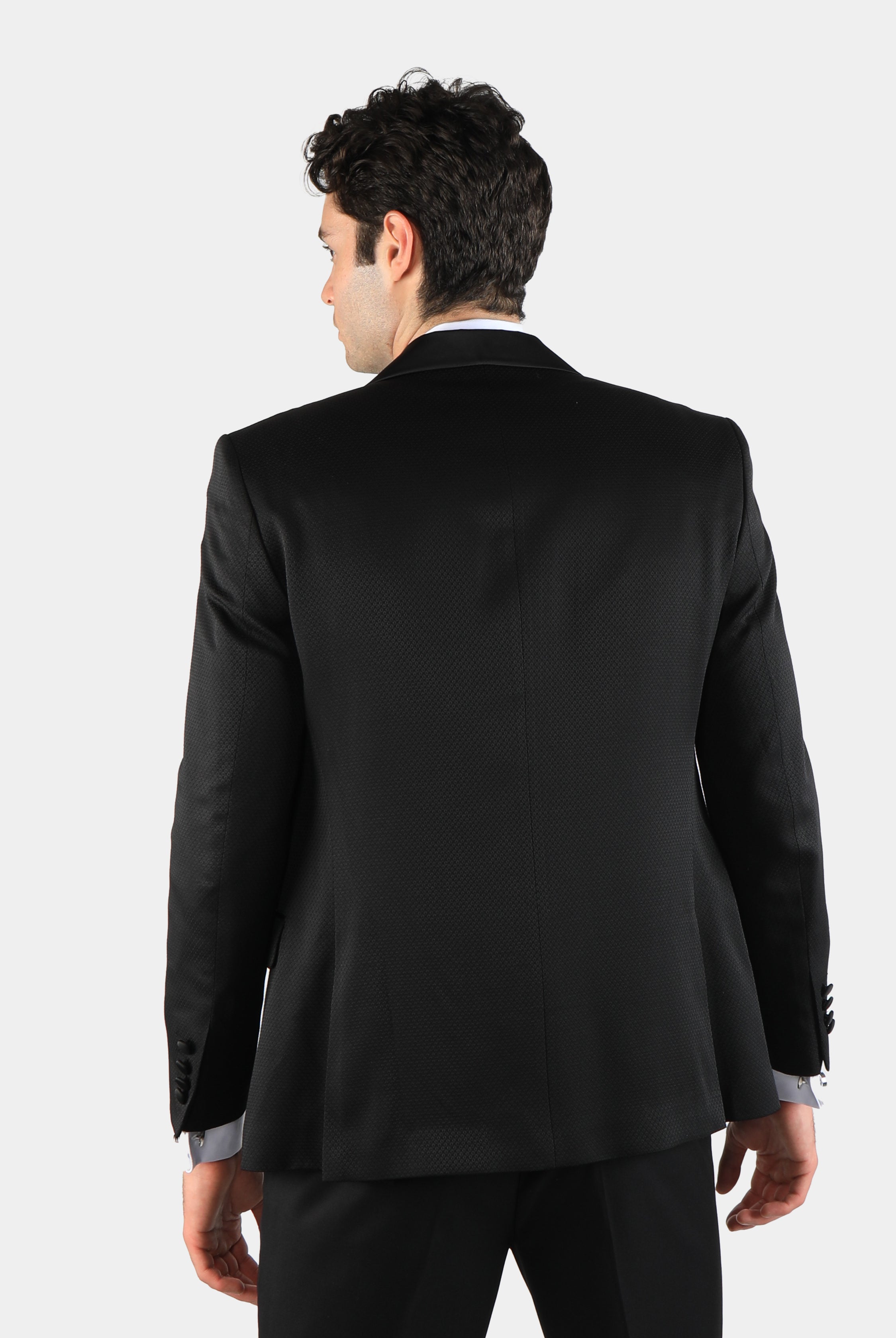 alt="DKS black slim tuxedo suit with vest back view on model"